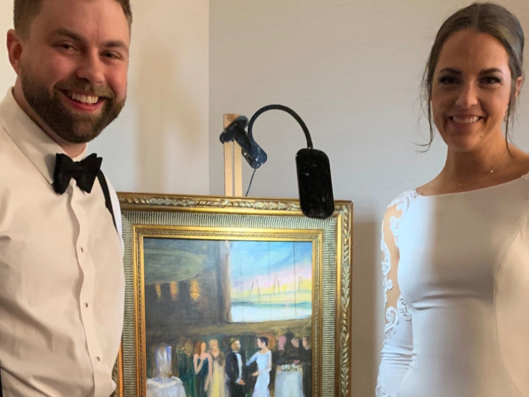 men and women beside a paintingss
